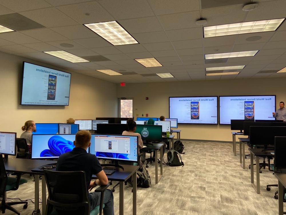 A Computing Science professor teach students in the computer lab.